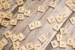 scrabble tiles on a wooden table with the word rock