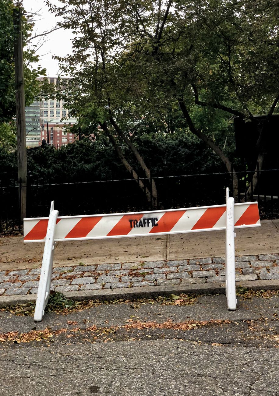 red and white barricade the side of the street
